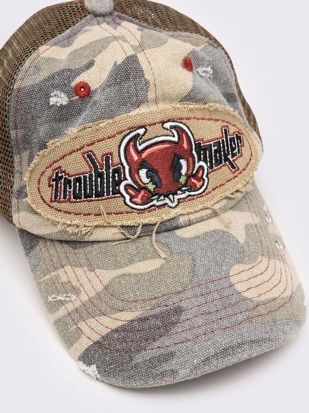 TROUBLEMAKER CAMO DISTRESSED TRUCKER CAP